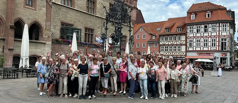Frauengruppe vor Wahrzeichen von Göttingen “Das Gänseliesel“